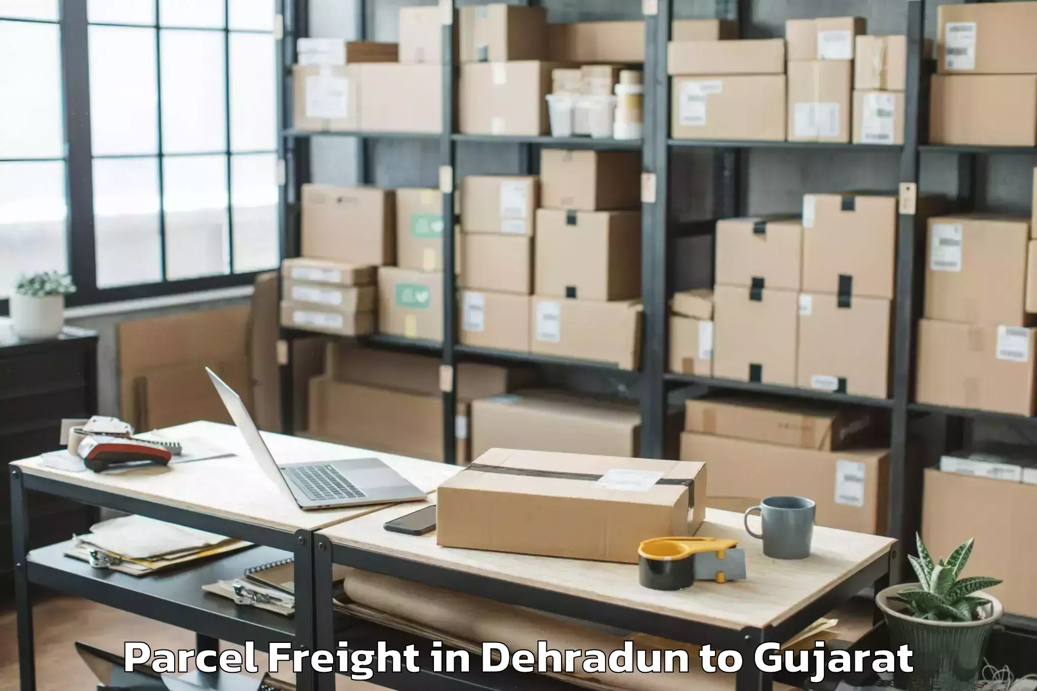 Book Dehradun to Satlasana Parcel Freight Online